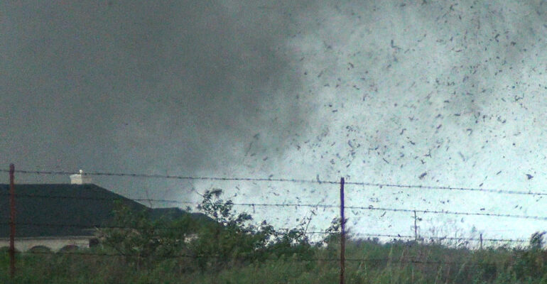 Debris in the air as the tornado approaches Sooner Rd. Video Still